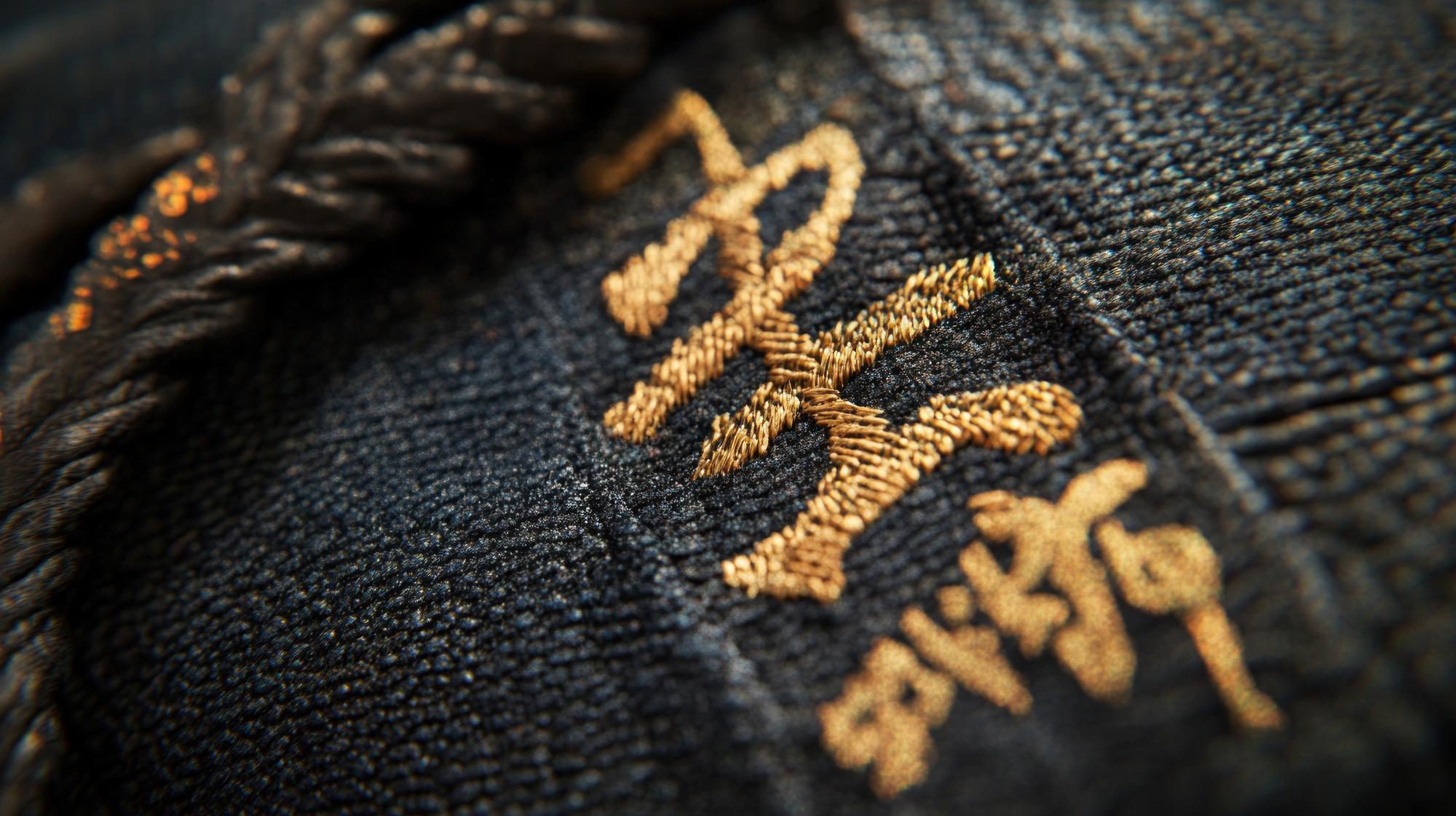 Close-up luxury embroidered emblem on dark fabric